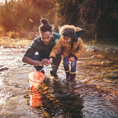 father and son fishing with fishing net in river ist925284270